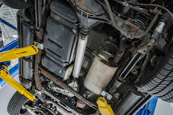 Underside of vehicle on lift showing exhaust system